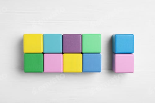 Preview: Flat lay composition with colorful cubes on white wooden background. Pareto principle concept