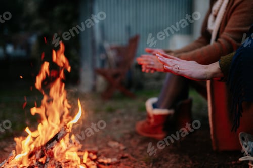 Preview: Shallow focus of people gathered around a fire outdoors