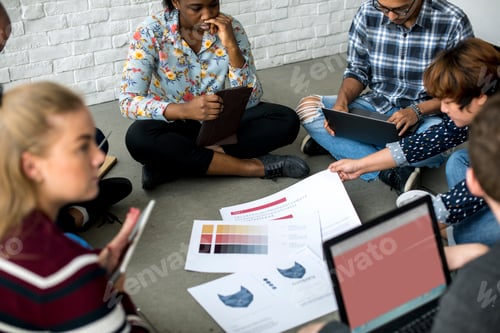 Preview: Group of people brainstorming sitting on the floor