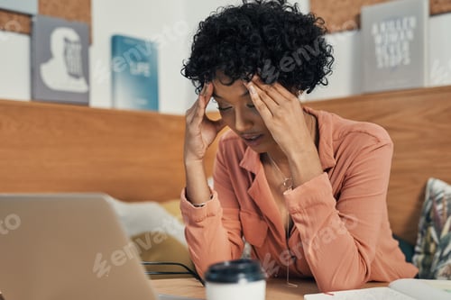 Preview: Im dealing with crisis after crisis. Shot of a woman looking stressed while working from a cafe.