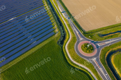 Preview: Aerial shot of a field of solar panels with a round road intersection