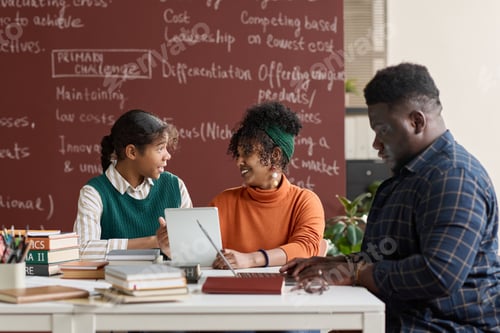 Preview: Group of Black People Discussing School Project in Classroom Setting