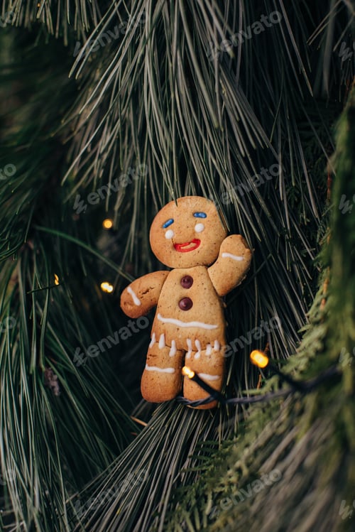 Preview: Gingerbread man on the background of a Christmas tree.