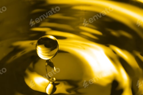 Preview: Splash of golden oily liquid with drop as background, closeup. Space for text