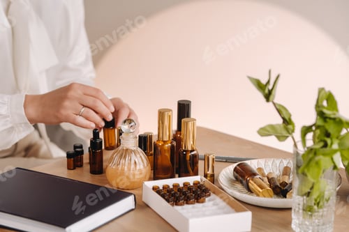 Preview: Close-up of a Woman's hands applying essential oil on her wrist indoors