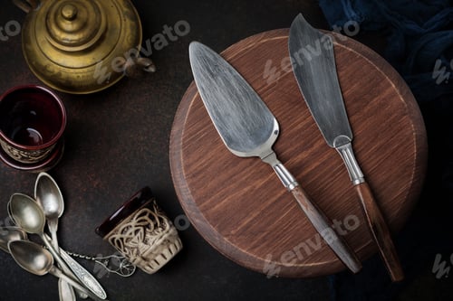 Preview: Vintage spatula and knife for cakes on a dark stone or concrete background. Selective focus. Top vie