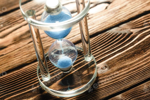 Preview: Modern hourglass on wooden background
