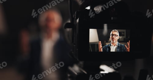 Preview: Mature man, video camera and screen with interview for talk, design tutorial or development process