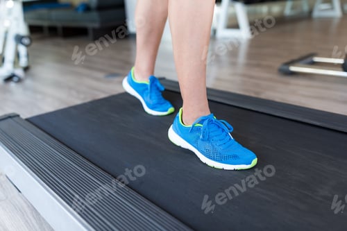 Preview: Woman running on the treadmill at the gym