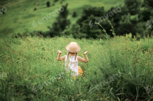 Preview: Little cute girl meditating on mountain. Portrait of child meditating