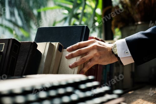 Preview: Closeup of hand getting a book