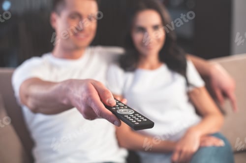 Preview: Joyful Married Couple Is Watching Tv Together. They Are Sitting On Comfortable Sofa And Cuddling
