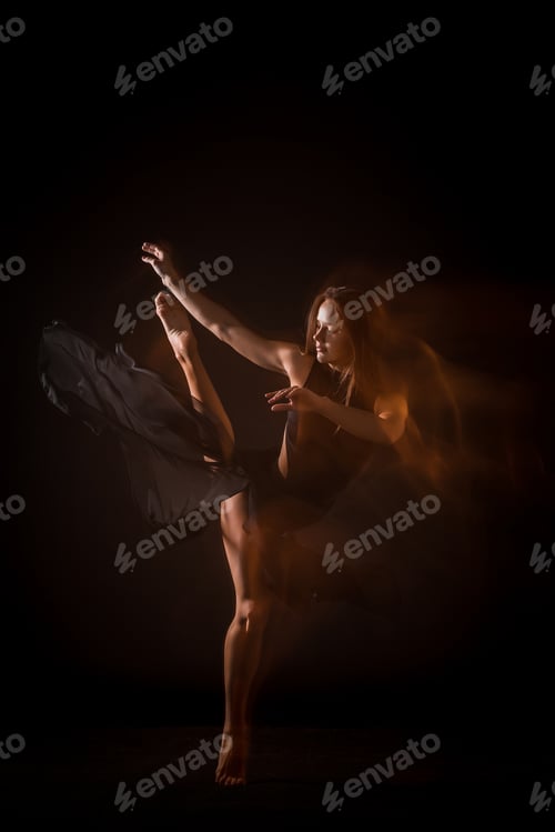 Preview: Young beautiful dancer dancing on black background