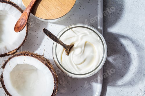 Preview: Vegan coconut yogurt in glass jars, white background, top view. Vegan food concept.