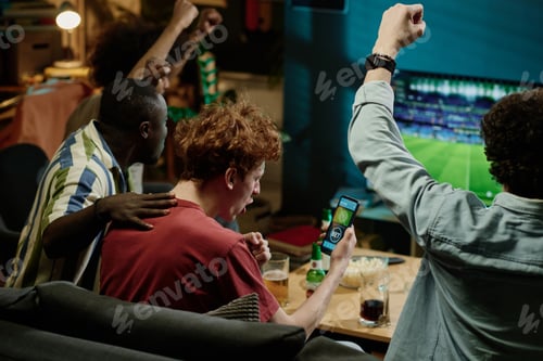 Preview: Happy Soccer Fans Watching Match On TV