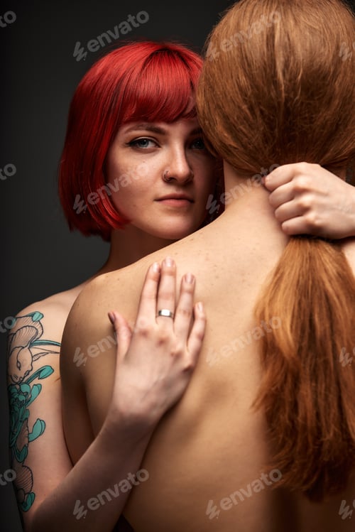 Preview: Sexy passionate couple in love in the studio. The woman's arms embrace a handsome half-naked man