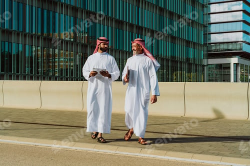 Preview: Arab businessmen discussing project outside modern building