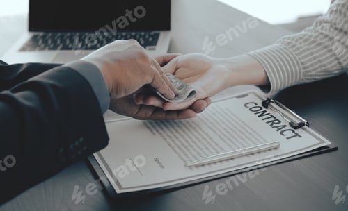 Preview: Businessman hand holding dollar bank note money to bribe financial officials or Boss is payout staff