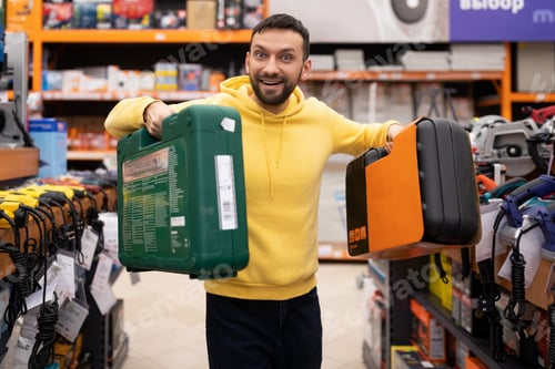 Preview: a satisfied customer in a hardware store who purchased a drill and a cordless screwdriver in plastic