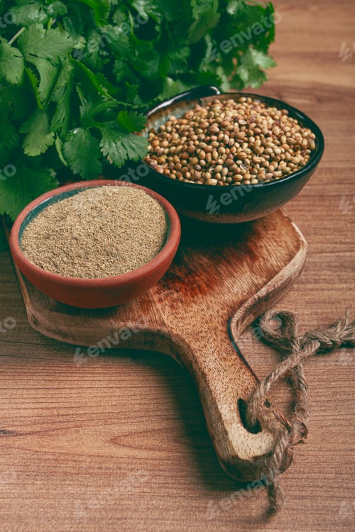 Preview: a bunch of fresh cilantro, coriander seeds and powder bowls, close-up, top view, no people,