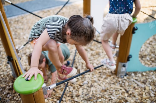 Preview: Group of small nursery school children playing outdoors on playground, climbing