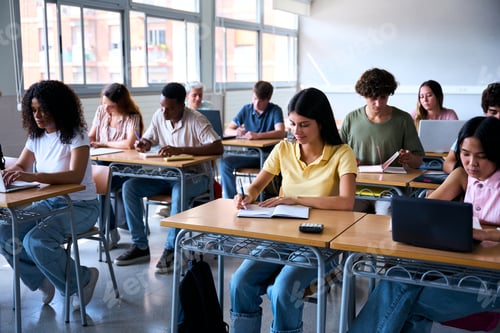 Preview: A diverse group of multiracial students aged 18 to 20 in a classroom, attentively taking notes