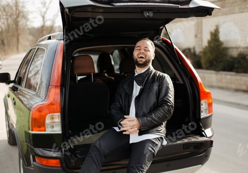 Preview: Portrait of fashionable well dressed man with beard posing outdoors