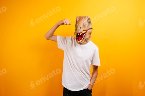 Preview: Teenager with T-Rex mask on yellow background