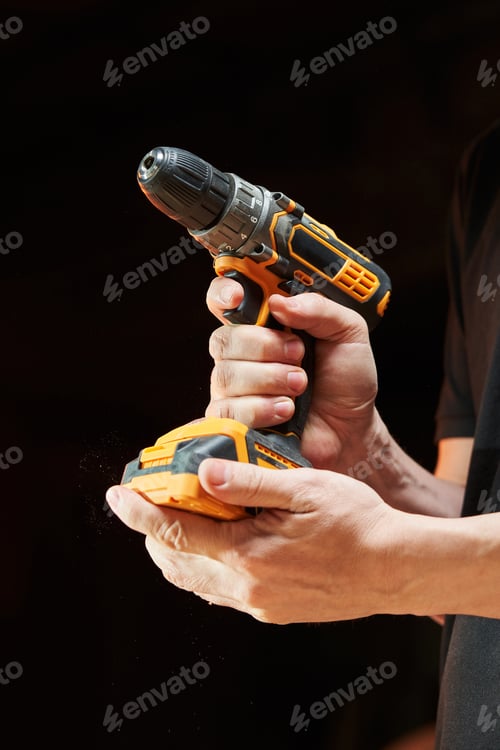 Preview: Hands Holding Yellow and Black Power Drill