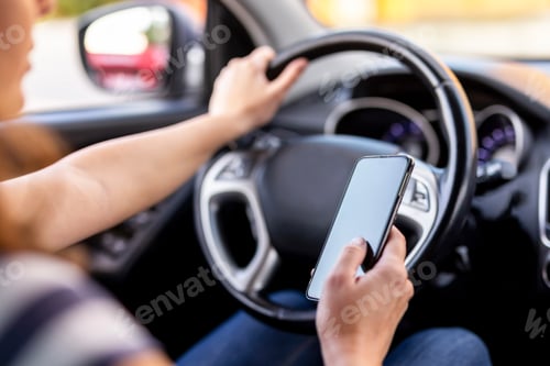 Preview: Woman driving a car and using phone