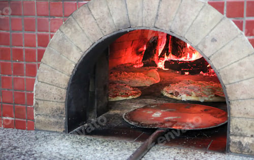 Preview: Pizza being baked in a wood-fired oven