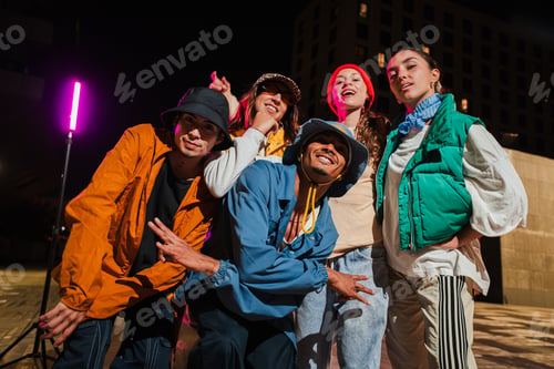 Preview: Group of Young Adult Friends Posing Cheerfully in Urban Street wear Fashion with Energetic