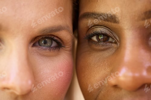 Close Up Beauty Portrait Showing Eyes Of Two Smiling Mature Women Against Natural Background