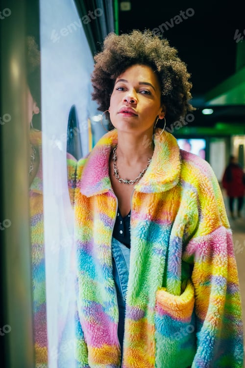 Preview: Young black woman indoors confident and independent looking camera