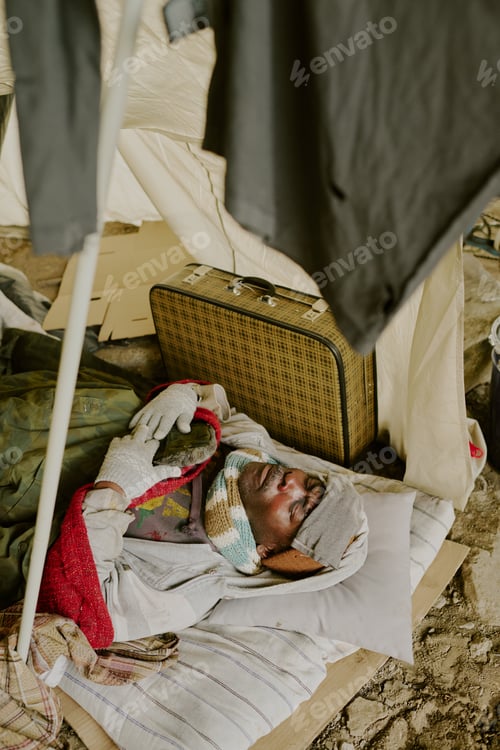 Preview: Homeless Black Man Resting Inside Makeshift Shelter during Difficult Times