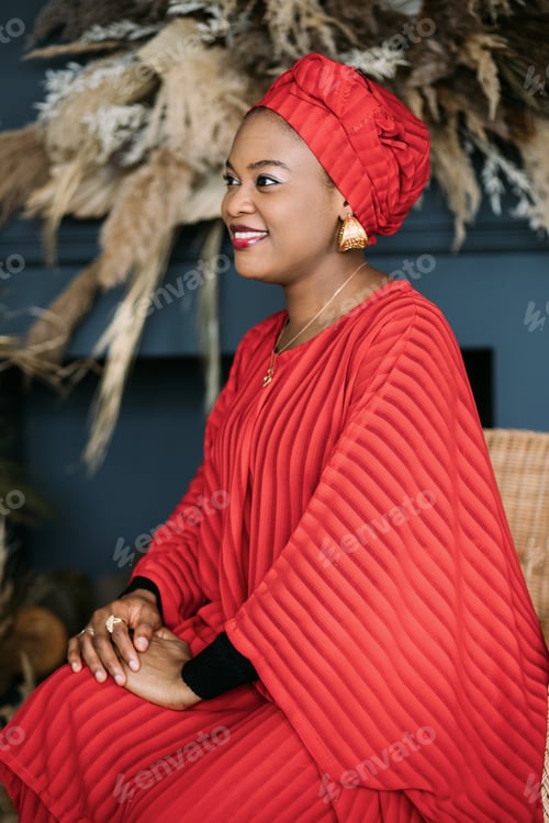 Preview: Waist up portrait of beautiful African-American female model in red ethnic dress and headwrap