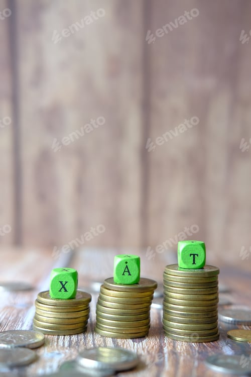 Preview: Wooden block with a TAX word on stack of coins