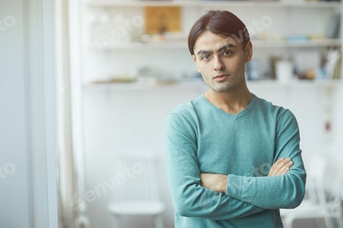 Preview: Young man standing at office