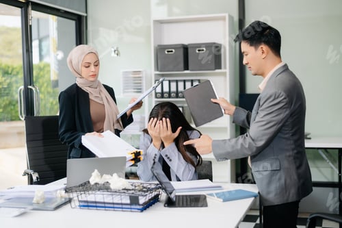 Preview: Furious Asian businesspeople arguing strongly after making a mistake at work in office