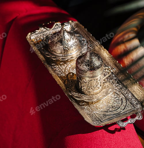 Preview: Traditional silver coffee set displayed on a vibrant red tablecloth