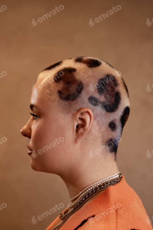 Preview: Side view portrait of young woman with buzzcut cheetah print