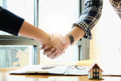 Preview: Real estate agent and customers shaking hands together celebrating finished contract