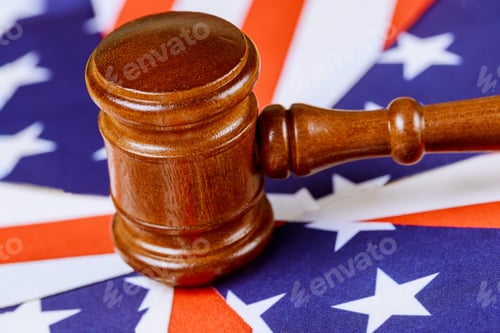 Preview: Law family concept judge's gavel on american dollars with wedding rings
