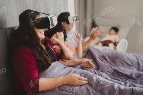 Preview: Virtual reality family in bed, smiling and playing together