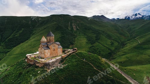 Preview: aerial view of old castle in green cloudy mountains, Georgia