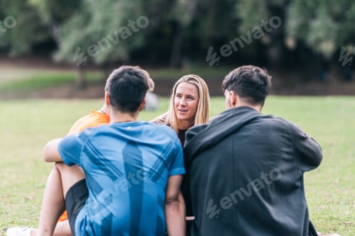 Preview: Friends chatting while sitting on a park after a yoga session