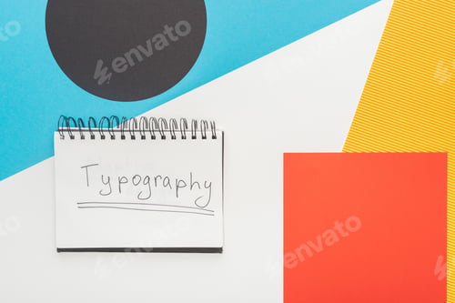 Preview: top view of notebook with typography lettering on abstract geometric background