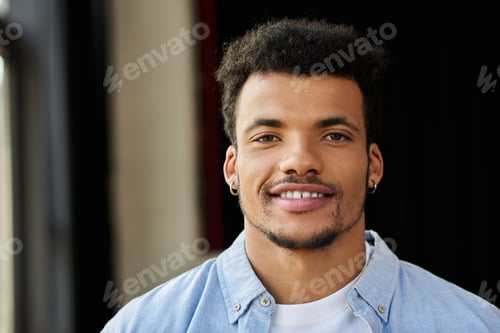 Preview: Handsome man smiling warmly indoors with soft lighting creating an inviting atmosphere