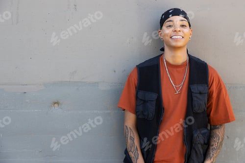 Preview: Young African American woman wearing black bandana and a vest outside