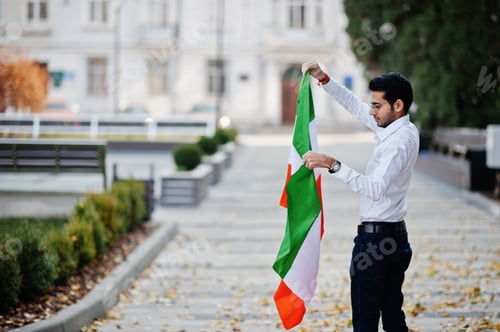 Preview: Young Man Holding a Flag Outside Building